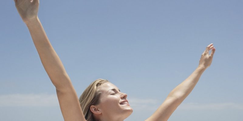 happy woman with arms up in the air